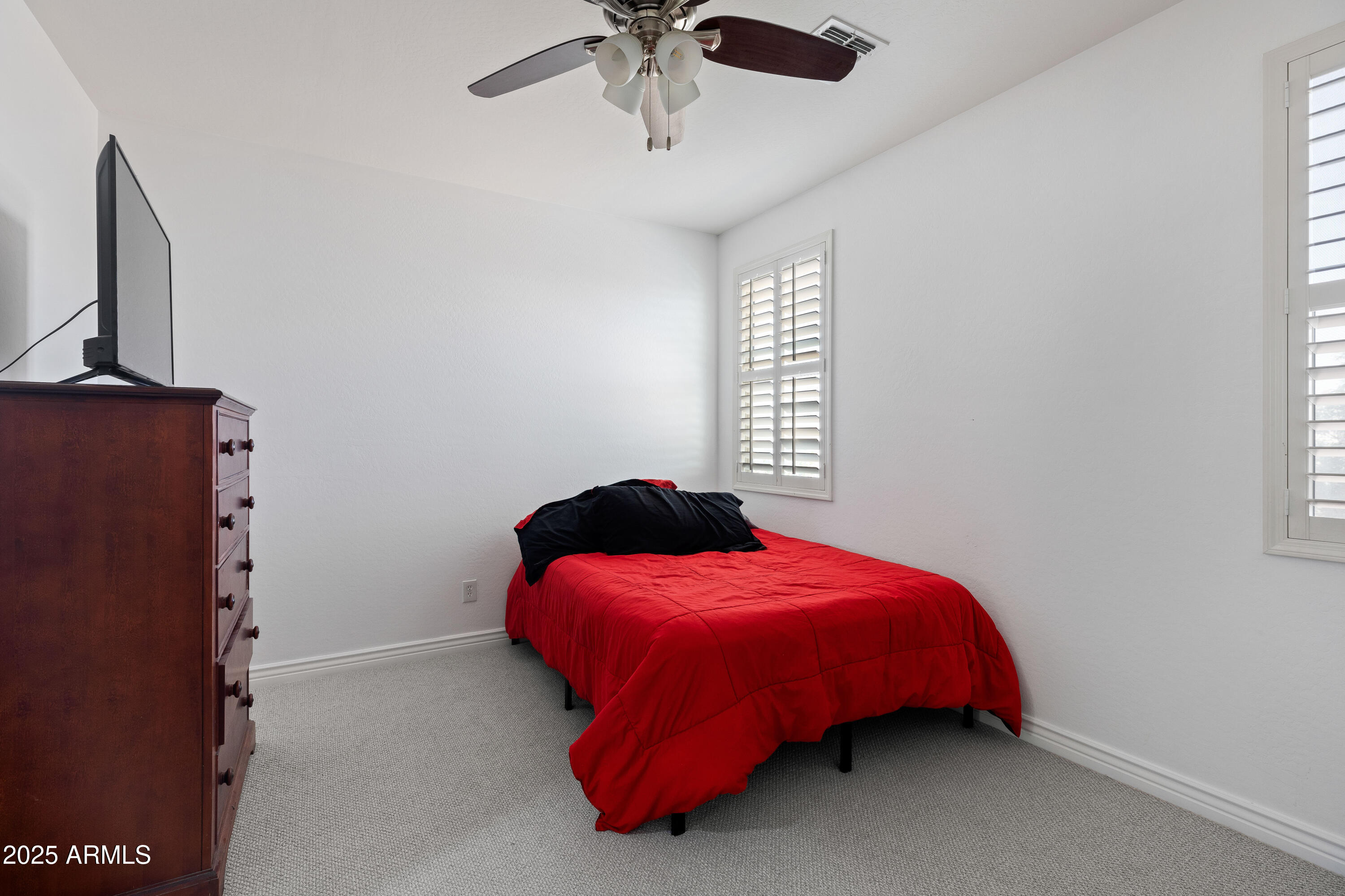 18649 West Williams Street Goodyear, AZ 85338 - Photo 24 of 42 a bedroom with a bed and window