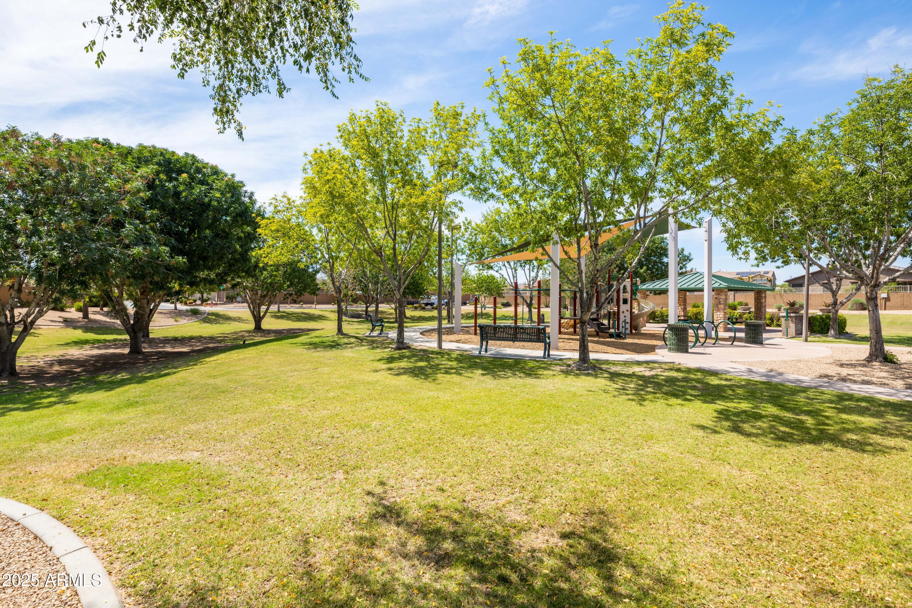 18649 West Williams Street Goodyear, AZ 85338 - Photo 40 of 42 a view of swimming pool with outdoor seating and trees in the background