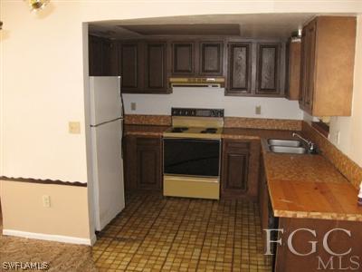 18320 Useppa Road Fort Myers, FL 33967 - Photo 2 of 10 a kitchen with a sink and cabinets