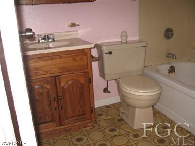 18320 Useppa Road Fort Myers, FL 33967 - Photo 7 of 10 a bathroom with a toilet sink and mirror