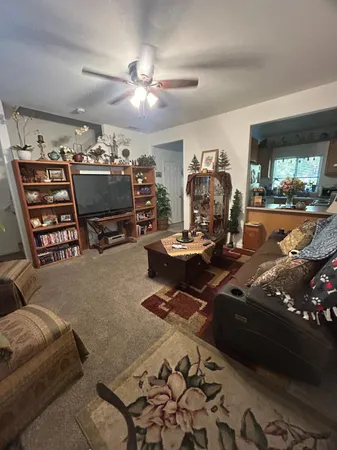 a view of a livingroom with furniture and a flat screen tv
