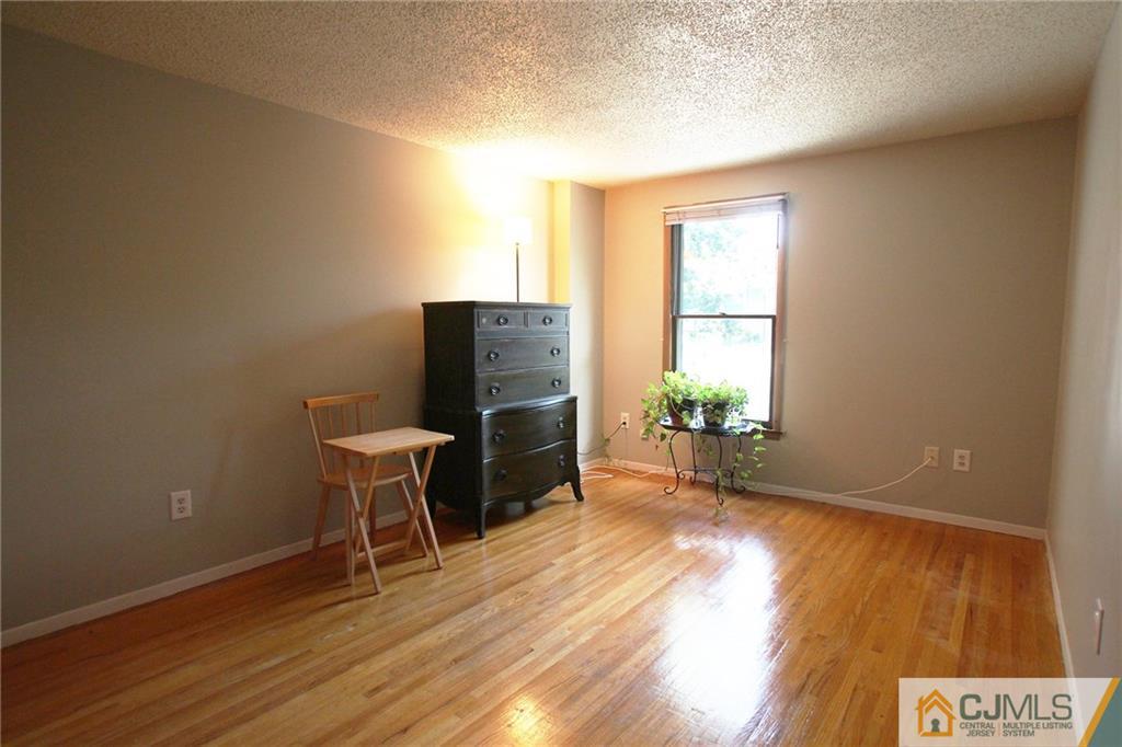 4704 Hana Road Edison, NJ 08817 - Photo 12 of 15 a view of a workspace with wooden floor and a window