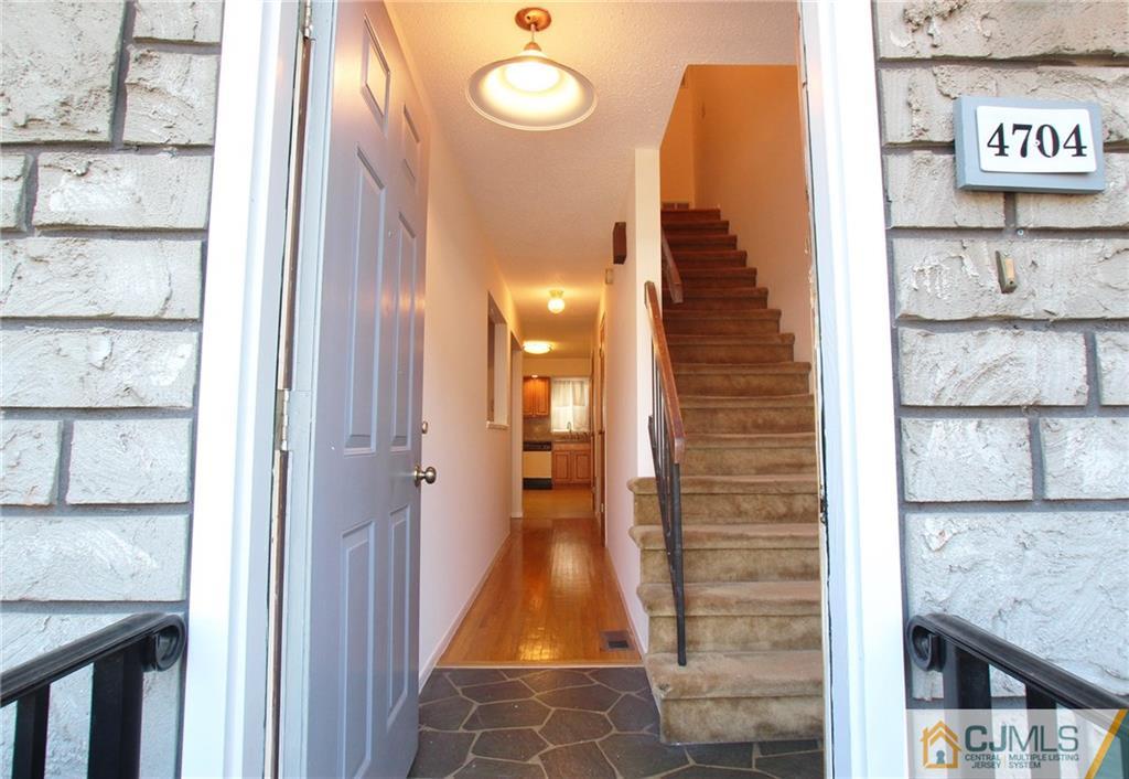 4704 Hana Road Edison, NJ 08817 - Photo 3 of 15 a view of a hallway and entryway with a rug