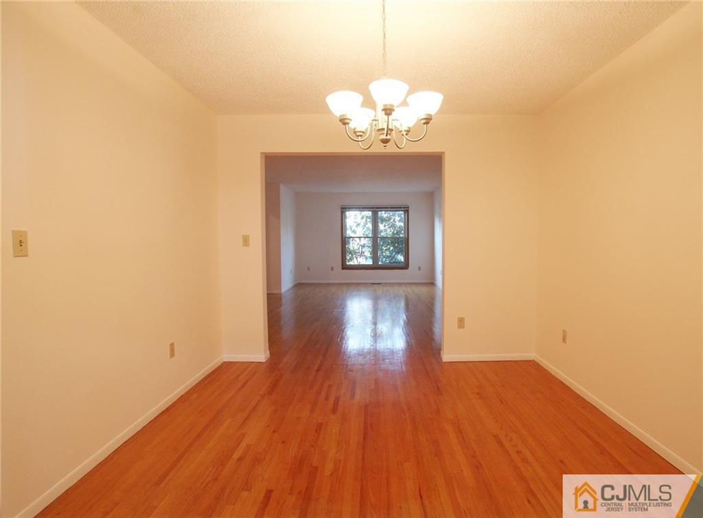 4704 Hana Road Edison, NJ 08817 - Photo 7 of 15 a view of an room with wooden floor and chandelier