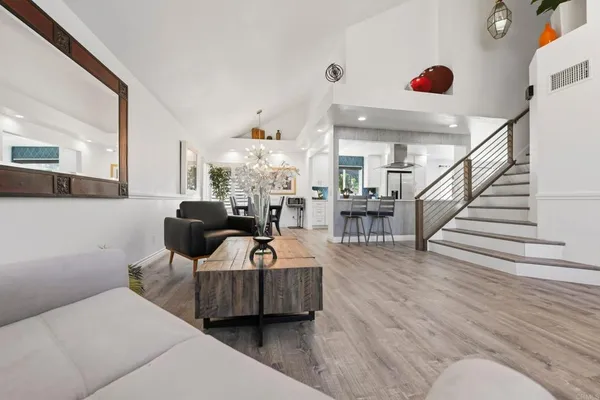 a kitchen with lots of counter top space and painting on the wall