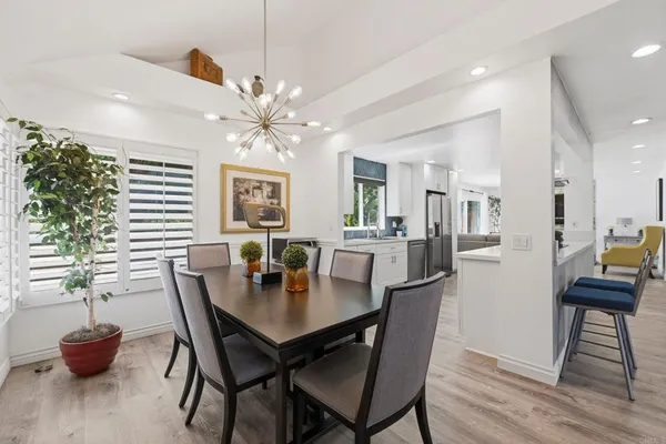 a kitchen with white cabinets and appliances