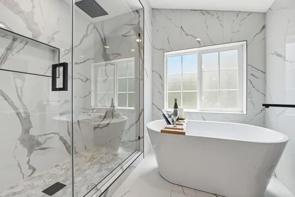 a bathroom with a sink a toilet a mirror and shower
