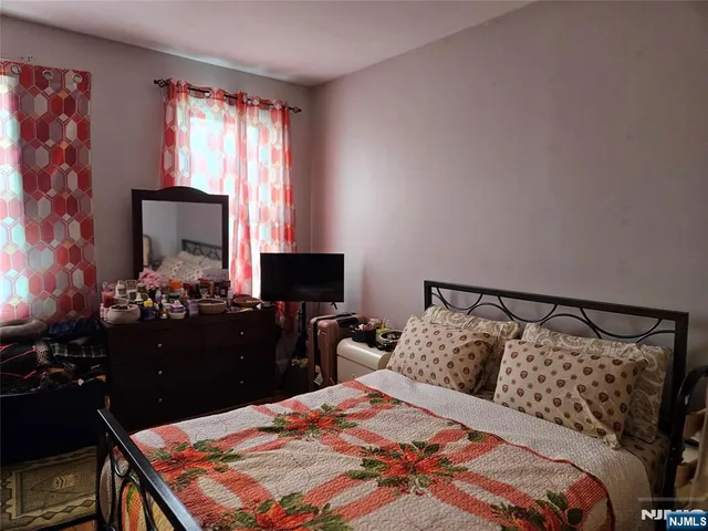 a bedroom with a bed and a lamp