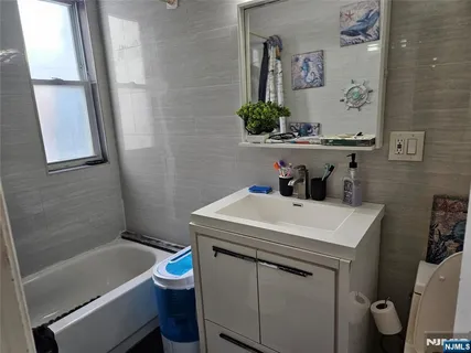 a bathroom with a sink a toilet and a bathtub