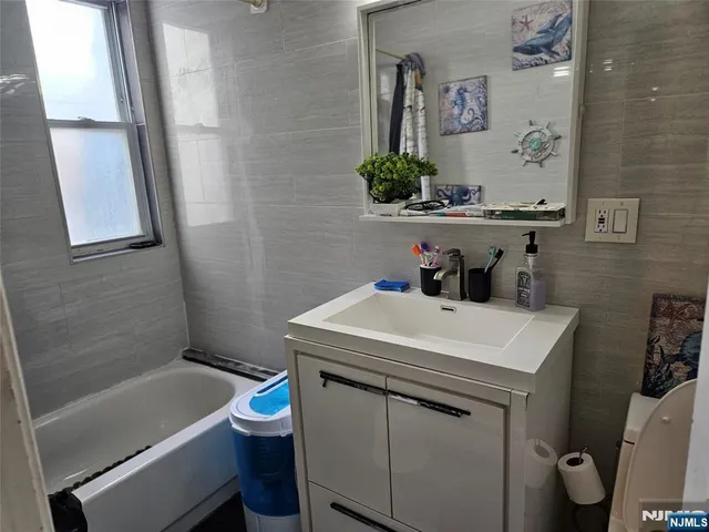 a bathroom with a sink a toilet and a bathtub