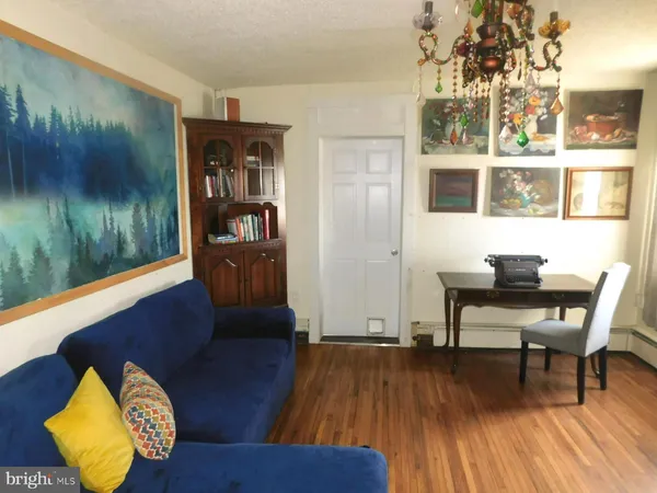 a workspace room with furniture and wooden floor