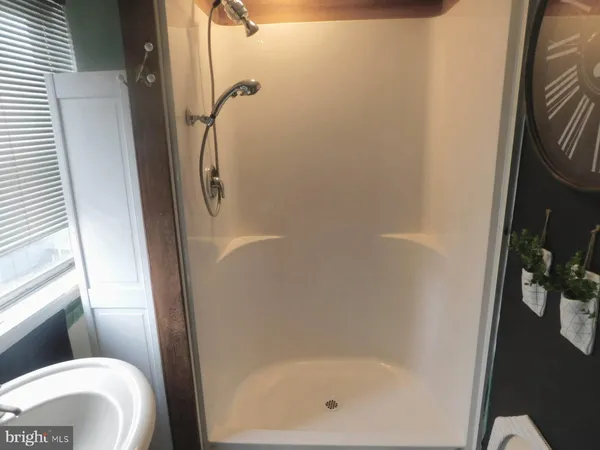 a bathroom with a shower and toilet