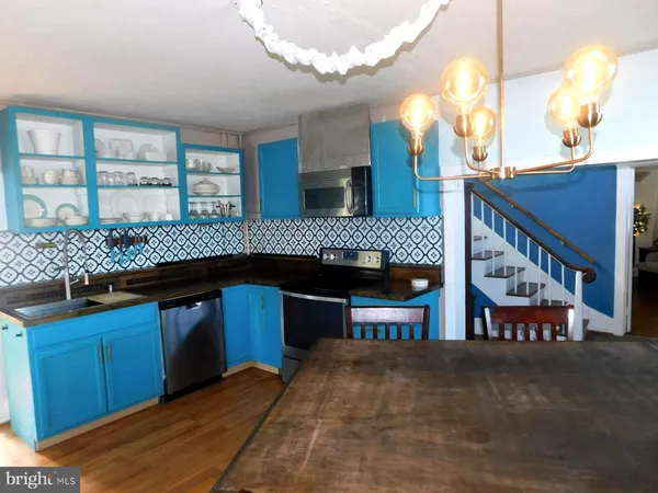 a kitchen with stainless steel appliances granite countertop a sink and cabinets