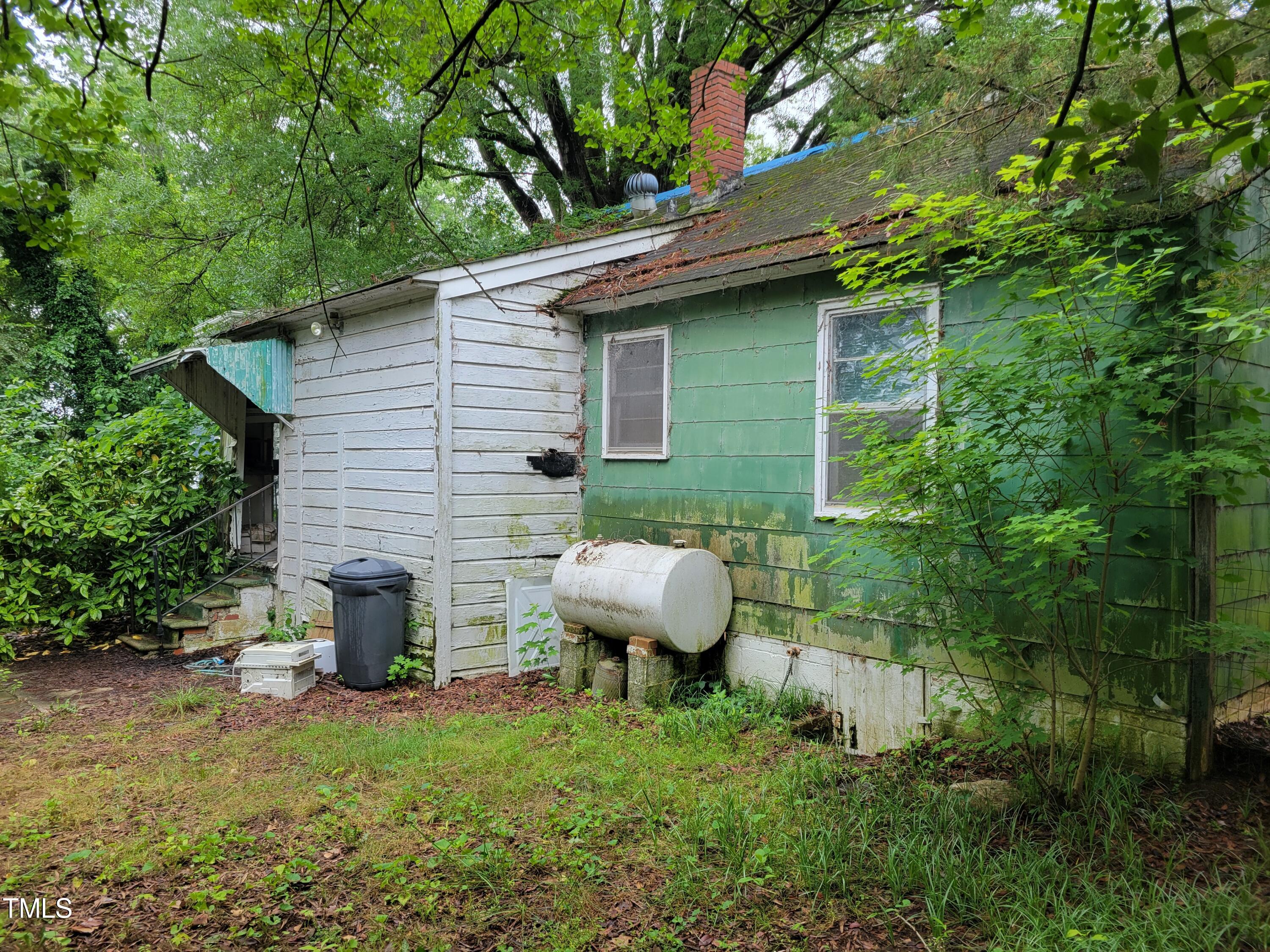 2521 Newbold Street Raleigh, NC 27603 - Photo 4 of 13 a view of a backyard with plants and large tree