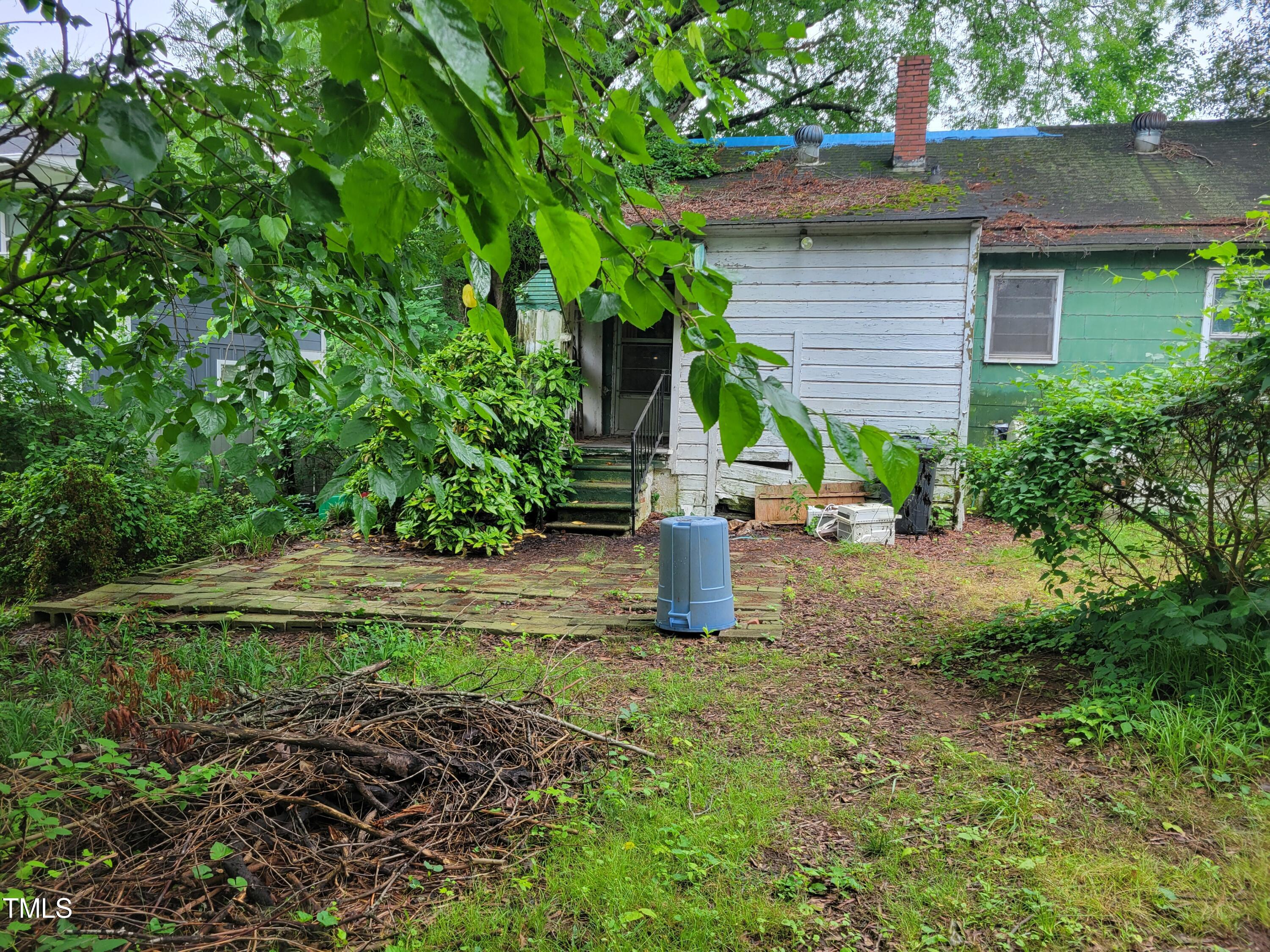 2521 Newbold Street Raleigh, NC 27603 - Photo 10 of 13 a view of a house with a yard and lawn chairs
