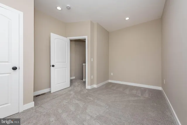 an empty room with closet area