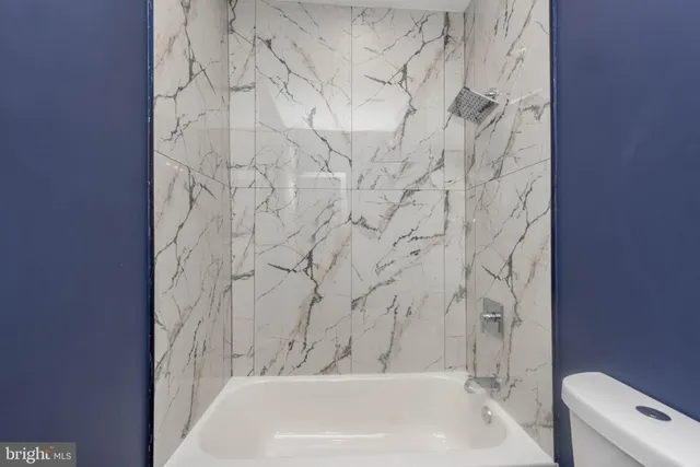 a bathroom with a bathtub and shower