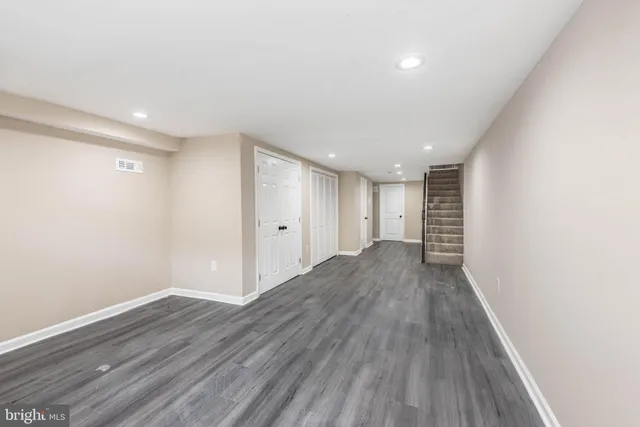 a view of a room with wooden floor