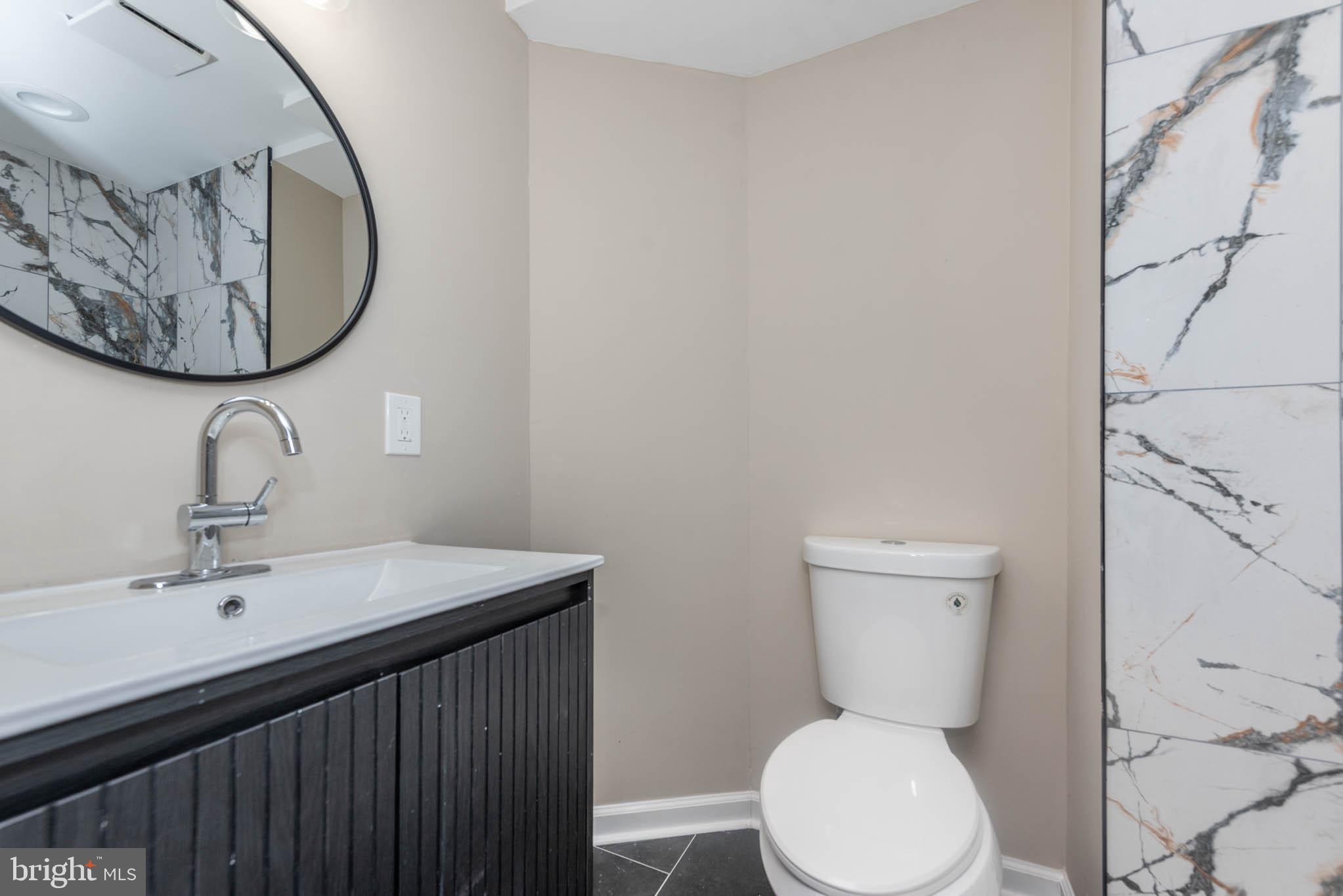 1713 North Bond Street Baltimore, MD 21213 - Photo 26 of 33 a bathroom with a toilet a sink and mirror