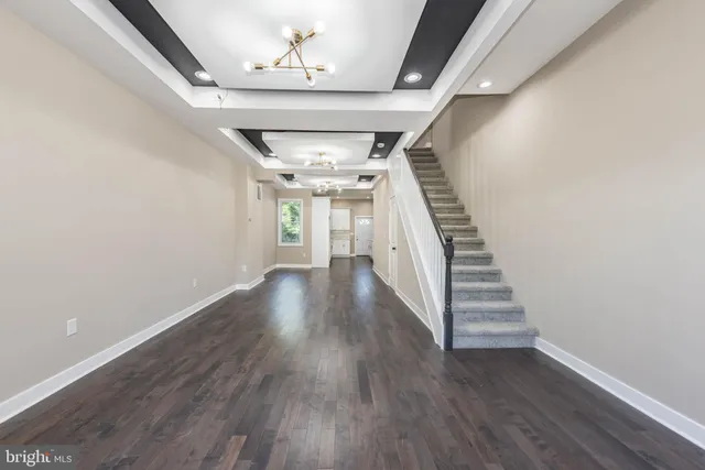wooden floor in an empty room with stairs