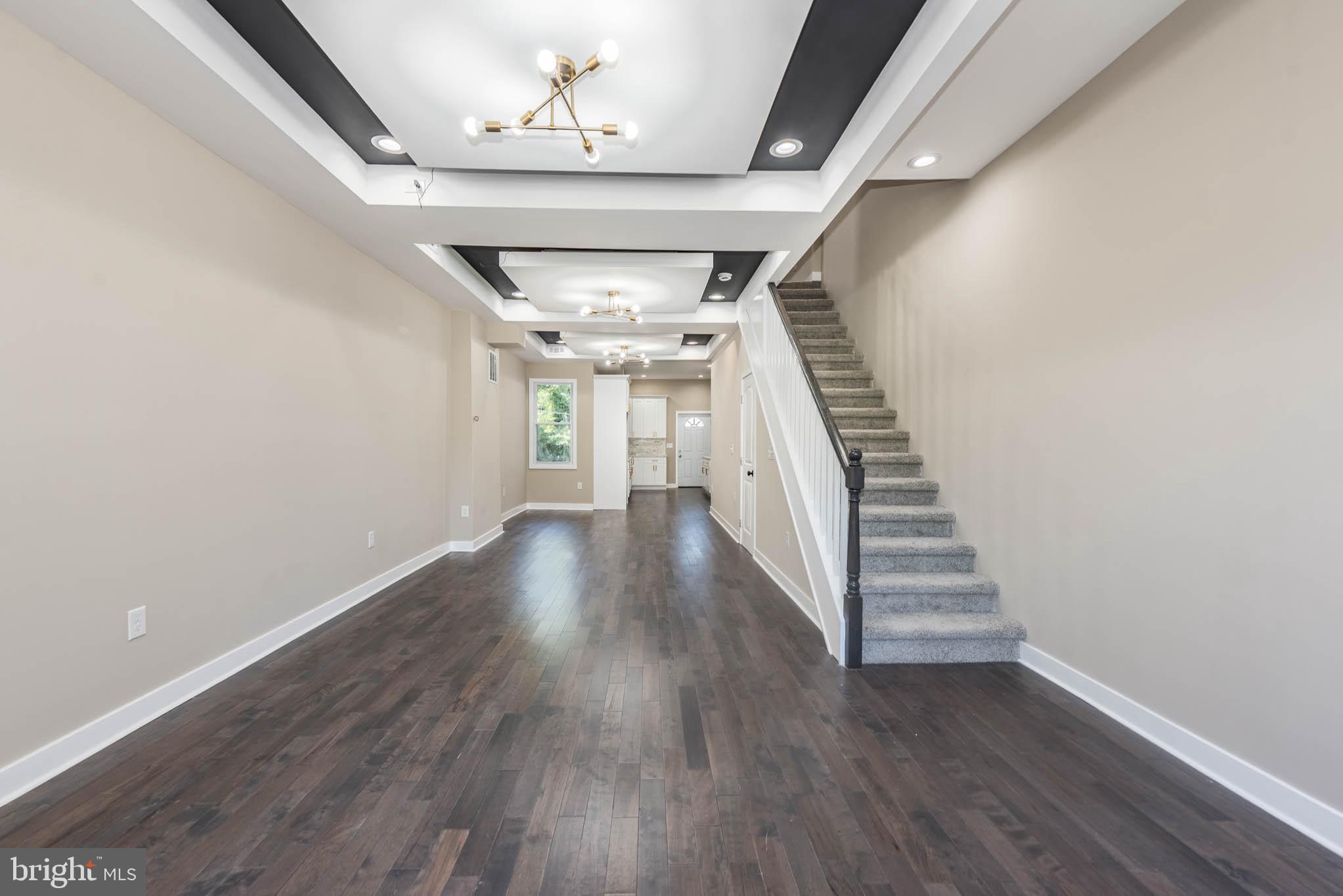 1713 North Bond Street Baltimore, MD 21213 - Photo 3 of 33 wooden floor in an empty room with stairs