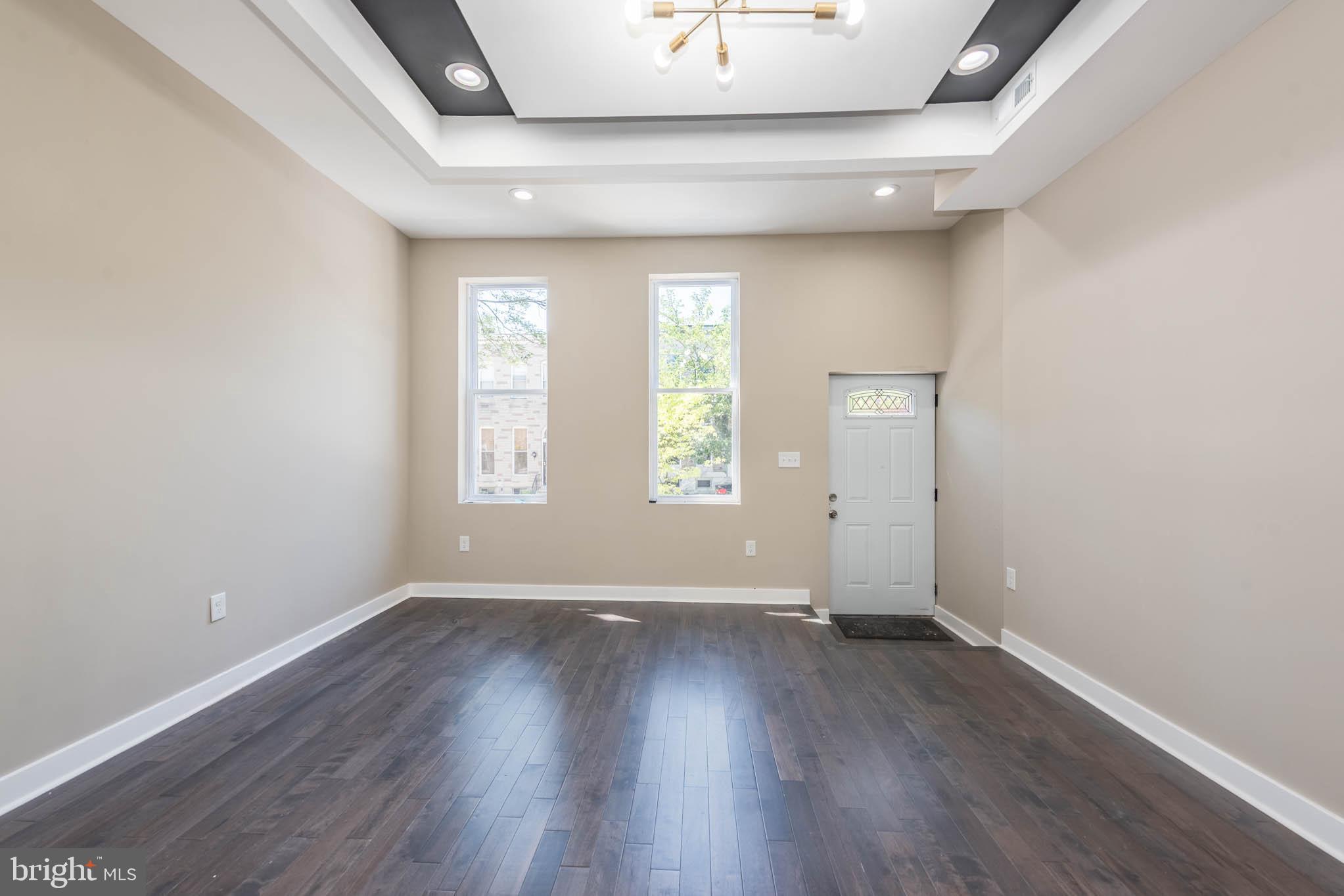 1713 North Bond Street Baltimore, MD 21213 - Photo 5 of 33 an empty room with wooden floor and windows