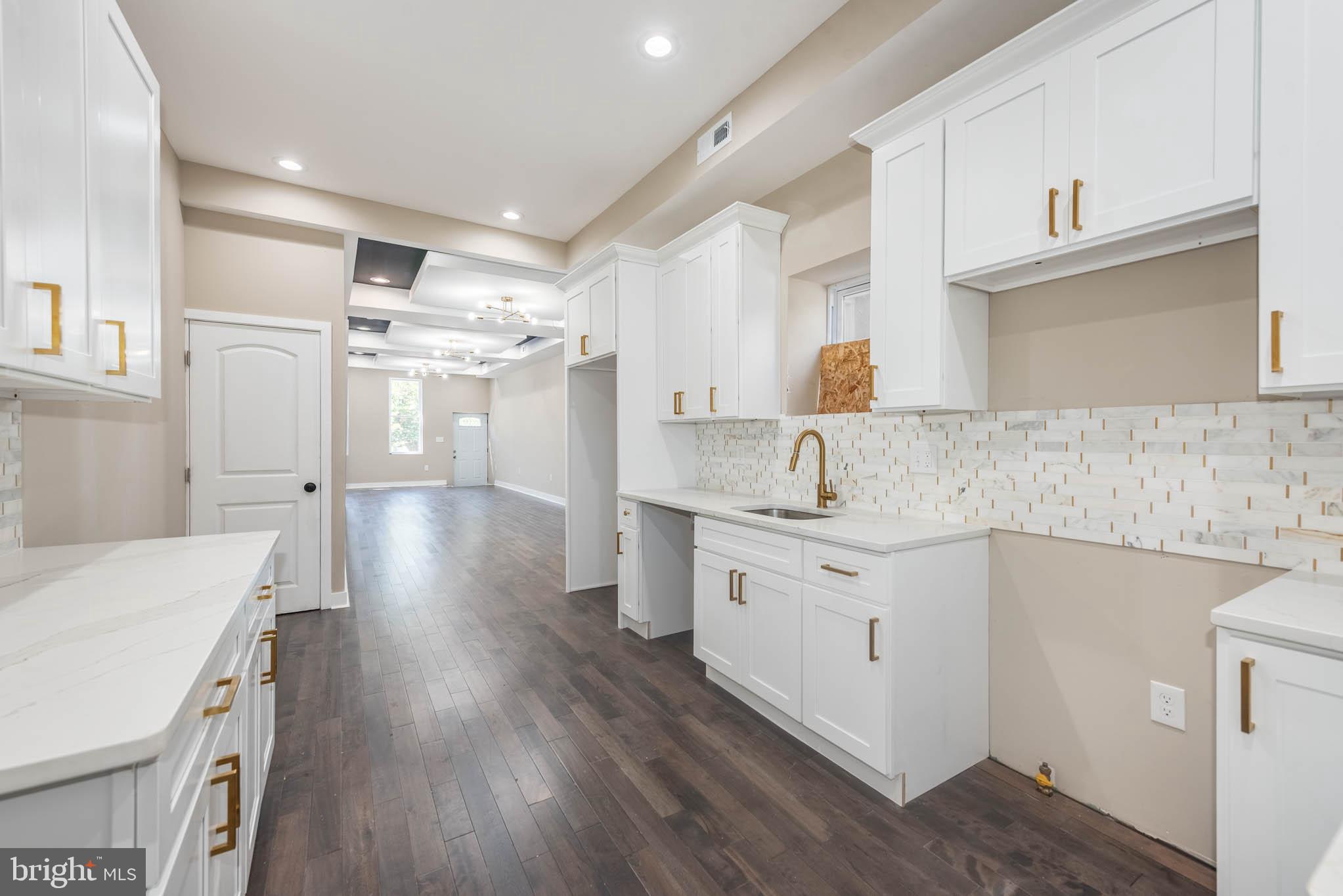 1713 North Bond Street Baltimore, MD 21213 - Photo 8 of 33 a kitchen with granite countertop a sink cabinets stainless steel appliances and a counter space