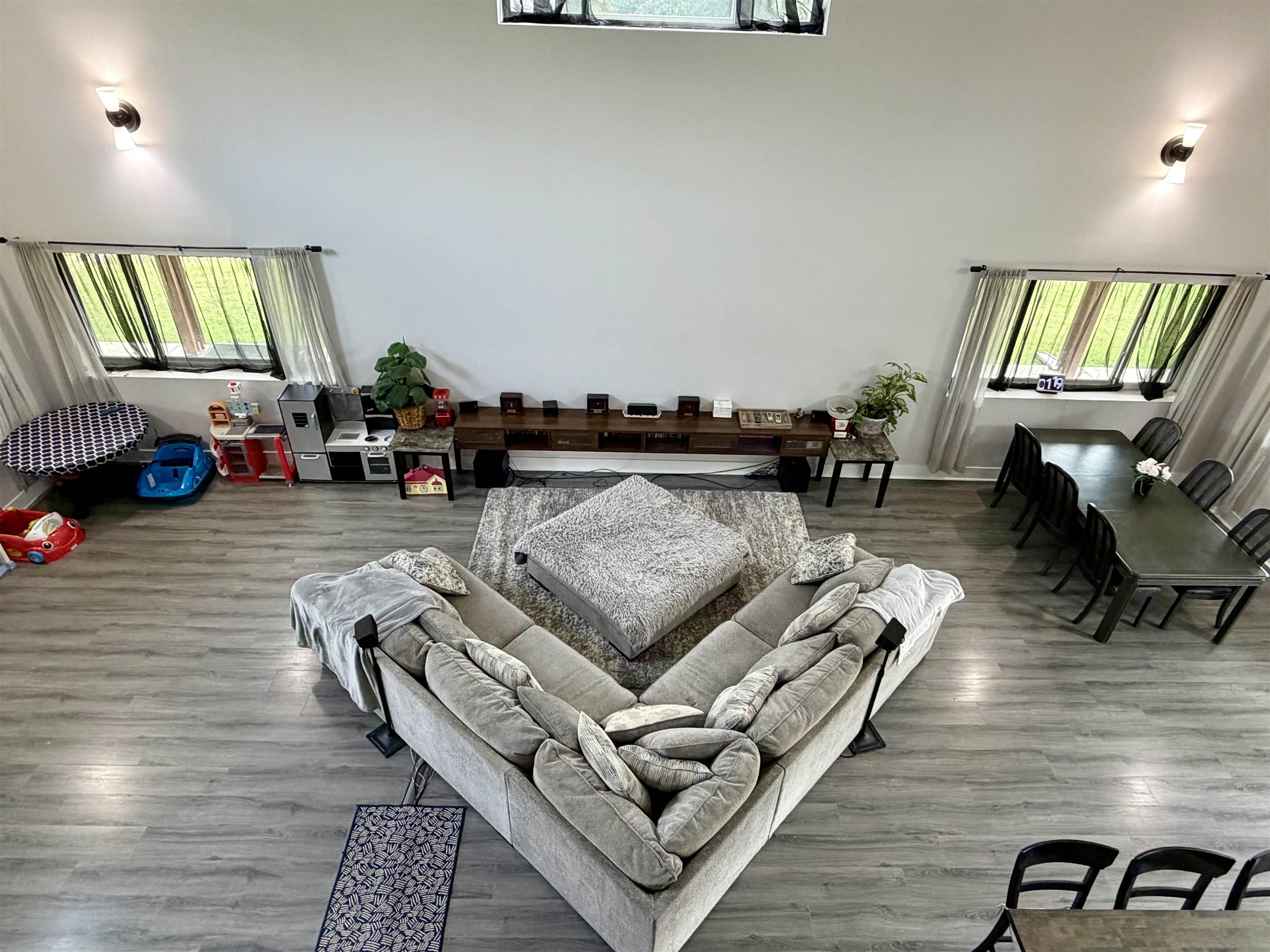 3670 Peavine Road Middleton, TN 38052 - Photo 32 of 36 Spacious open-concept room featuring high ceilings, wood-finish flooring, and multiple windows