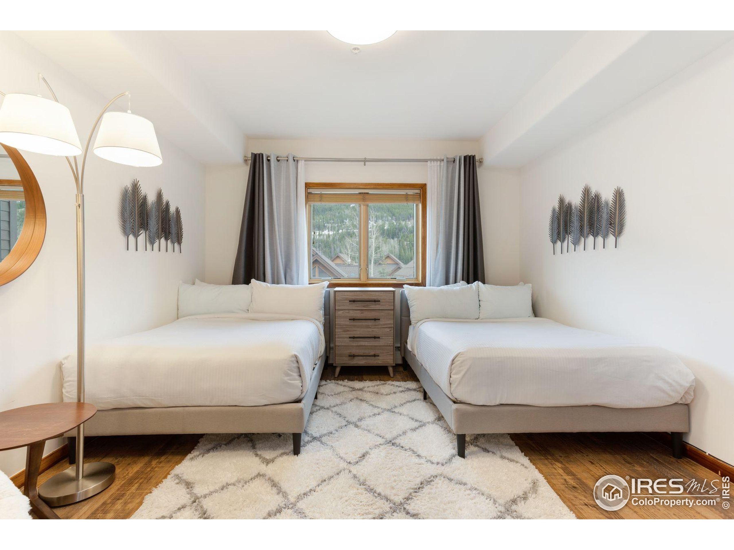 23110 Highway 6, Unit 5074 Dillon, CO 80435 - Photo 15 of 25 a bedroom with a bed a mirror and a large window