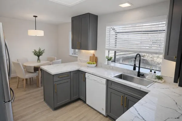 a kitchen with a sink cabinets and wooden floor