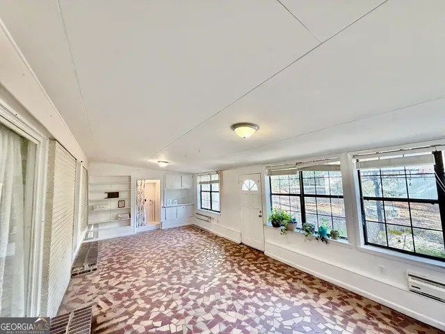 a view of a yard with plants and trees