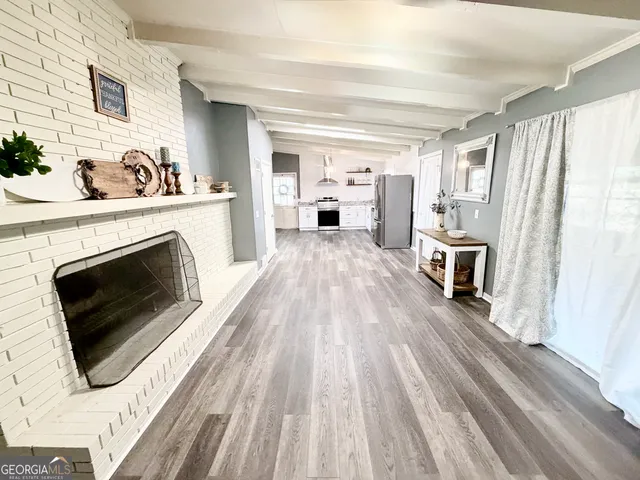 a view of a livingroom with an empty space and a fireplace
