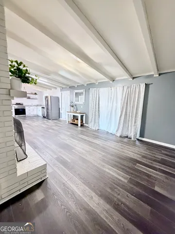 a view of a livingroom with hardwood floor and a ceiling fan