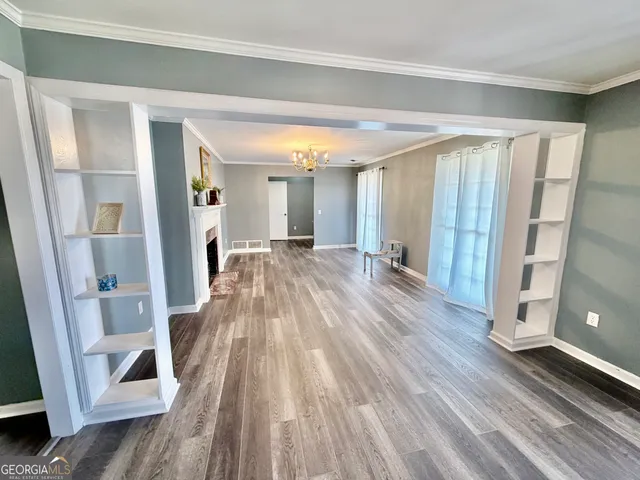 a view of a room with wooden floor and staircase