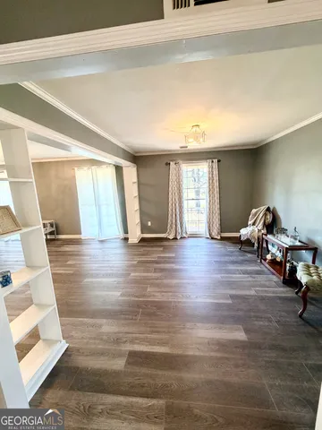a view of empty room with wooden floor and fireplace