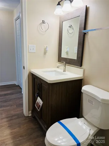 a bathroom with a sink toilet and mirror