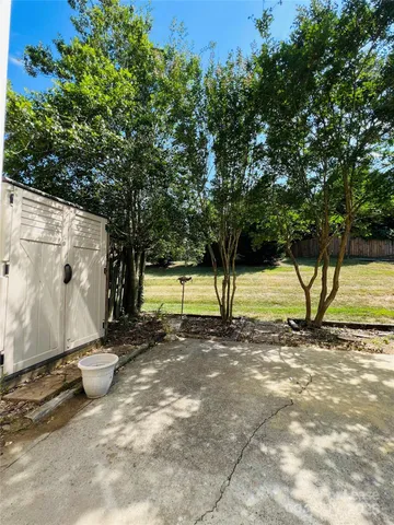 a view of a yard with wooden fence