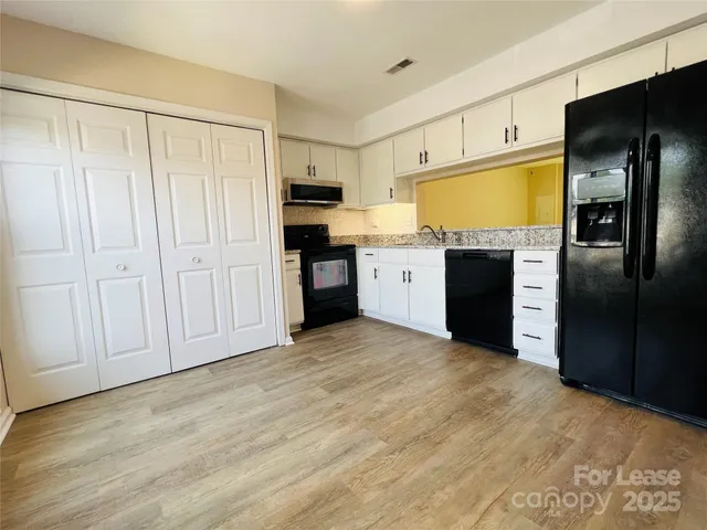 a kitchen with stainless steel appliances a refrigerator and a stove top oven