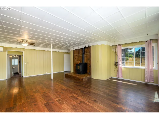 a kitchen with stainless steel appliances granite countertop a refrigerator a sink dishwasher a stove with wooden cabinets and floor