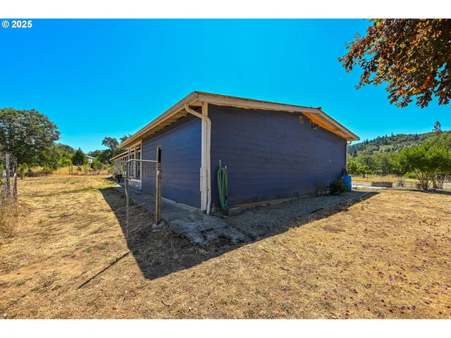 a backyard of a house with yard and outdoor seating
