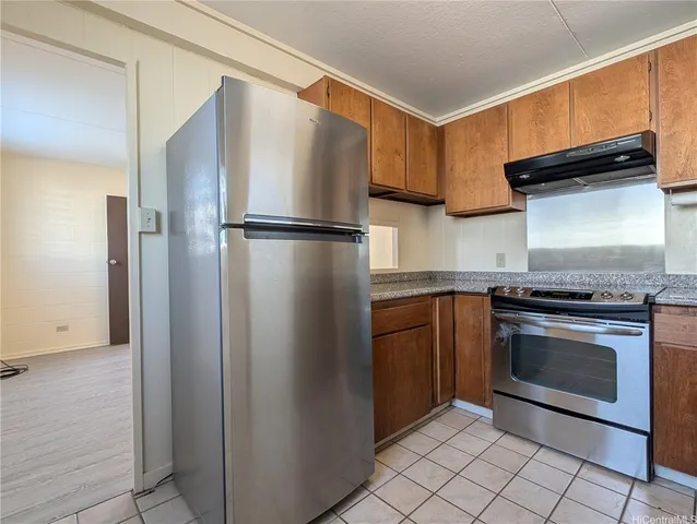 a kitchen with a refrigerator sink and cabinets