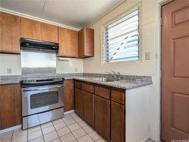 a kitchen with granite countertop cabinets stainless steel appliances and a sink