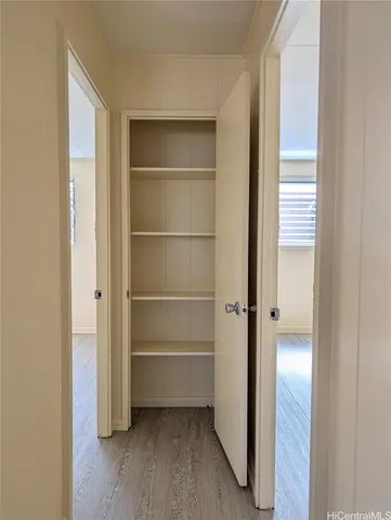 a view of a room with wooden floor