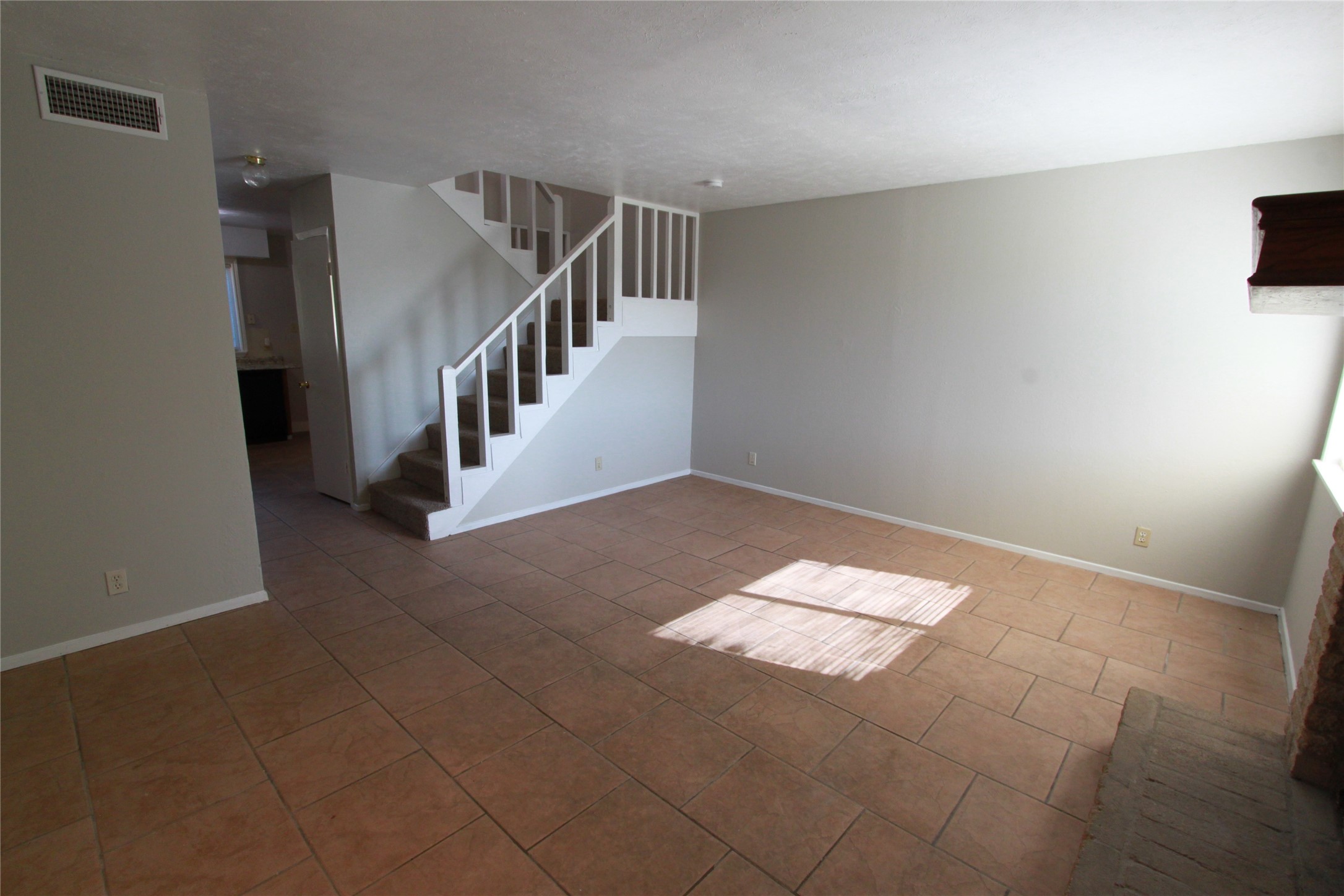 3904 Hudson Bend Road, Unit D Austin, TX 78734 - Photo 6 of 25 Unfurnished living room featuring stairway and light tile patterned flooring