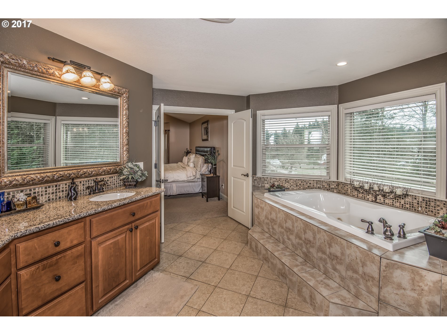 17980 Southeast Vogel Road Damascus, OR 97089 - Photo 20 of 32 a spacious bathroom with a granite countertop tub mirror and double vanity