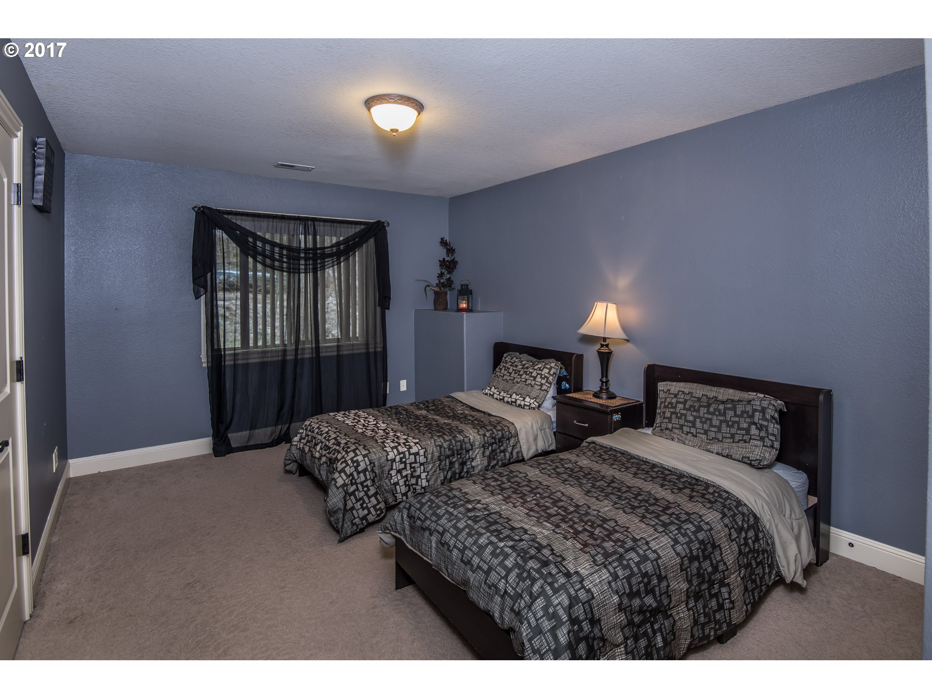 17980 Southeast Vogel Road Damascus, OR 97089 - Photo 24 of 32 a bedroom with two beds and a chandelier