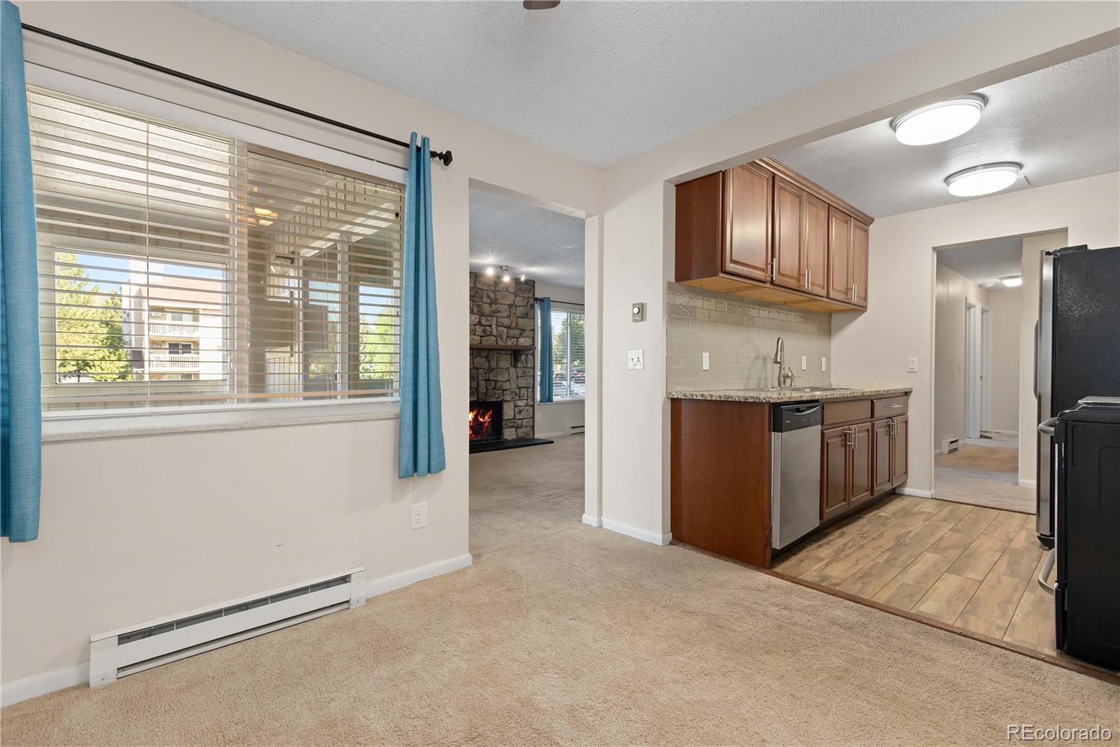 4068 South Atchison Way, Unit 202 Aurora, CO 80014 - Photo 11 of 33 a kitchen with stainless steel appliances granite countertop a refrigerator and a sink