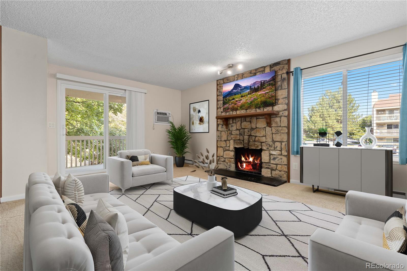 4068 South Atchison Way, Unit 202 Aurora, CO 80014 - Photo 2 of 33 a living room with furniture a fireplace and a large window