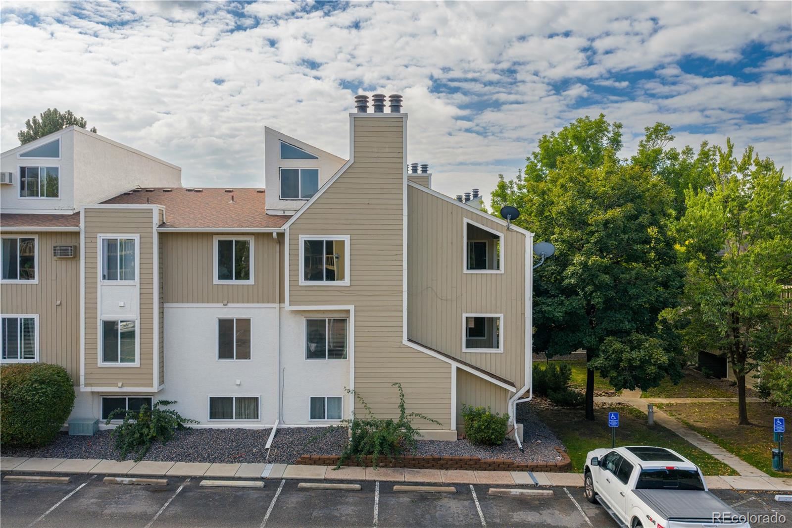 4068 South Atchison Way, Unit 202 Aurora, CO 80014 - Photo 25 of 33 a view of a white house with a yard