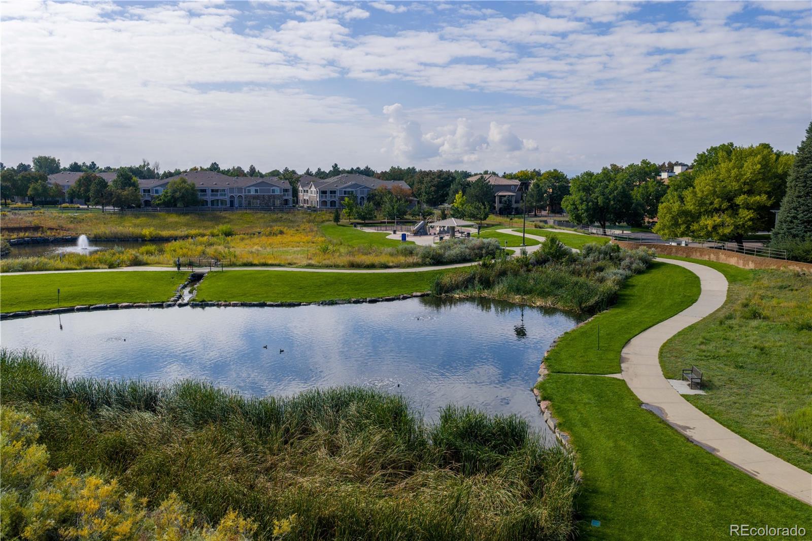 4068 South Atchison Way, Unit 202 Aurora, CO 80014 - Photo 29 of 33 a view of a lake with houses in the back